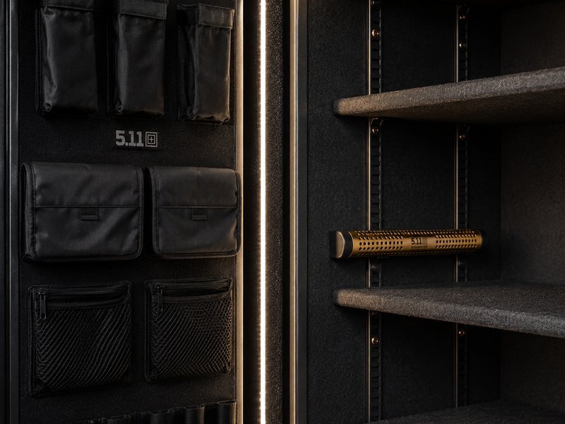 Interior of a premium gun safe showing LED-lit shelving and door organizer
